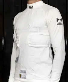 Athlete wearing a fitted white long-sleeve training shirt with embedded technology for performance tracking, showcasing a sleek design and practical features for sports enthusiasts.